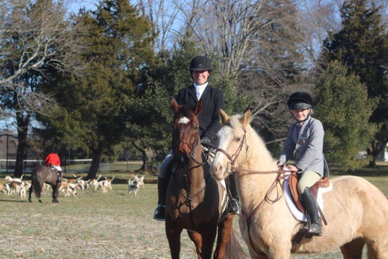 junior and adult in foxhunting attire with green spring valley hounds